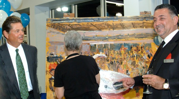Mercedes Benz President Ernst Lieb with Dealership Owner Terry Rafih enjoy Joan Zylkin's live event painting at the opening of Terry's DE. showroom.